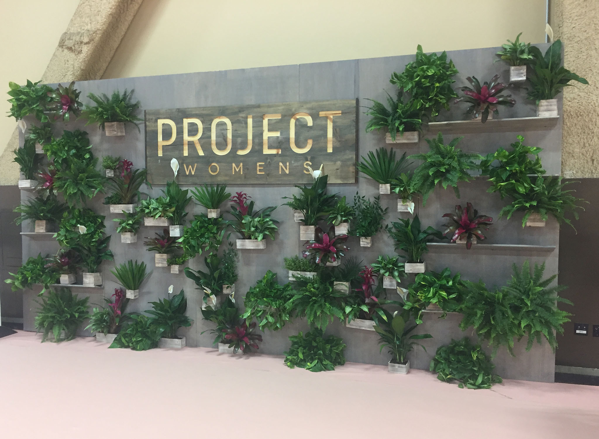 Project Living wall at trade show decorated with plants.