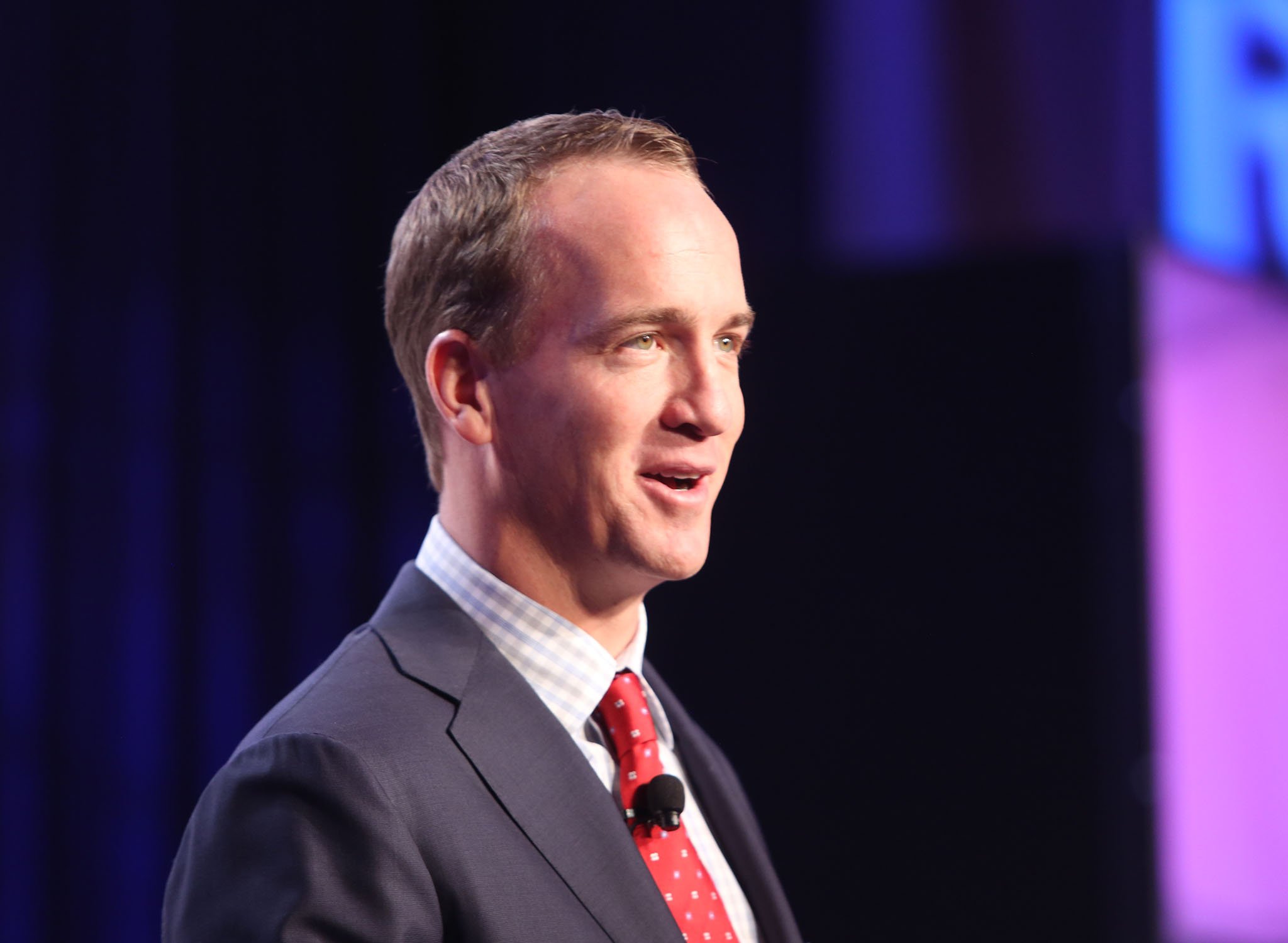Trade show photography of Peyton Manning giving a keynote speech.
