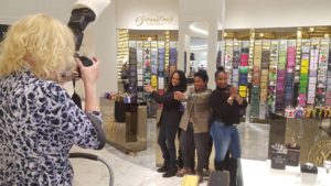 People being photographed in a trade show booth in Las Vegas.