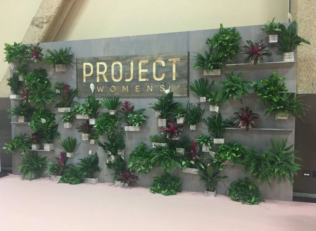 Project Womens fashion trade show booth theme with plants.