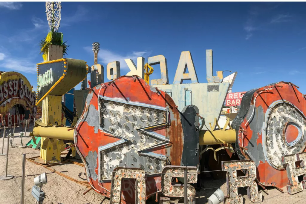 Old neon signs sitting on the ground.