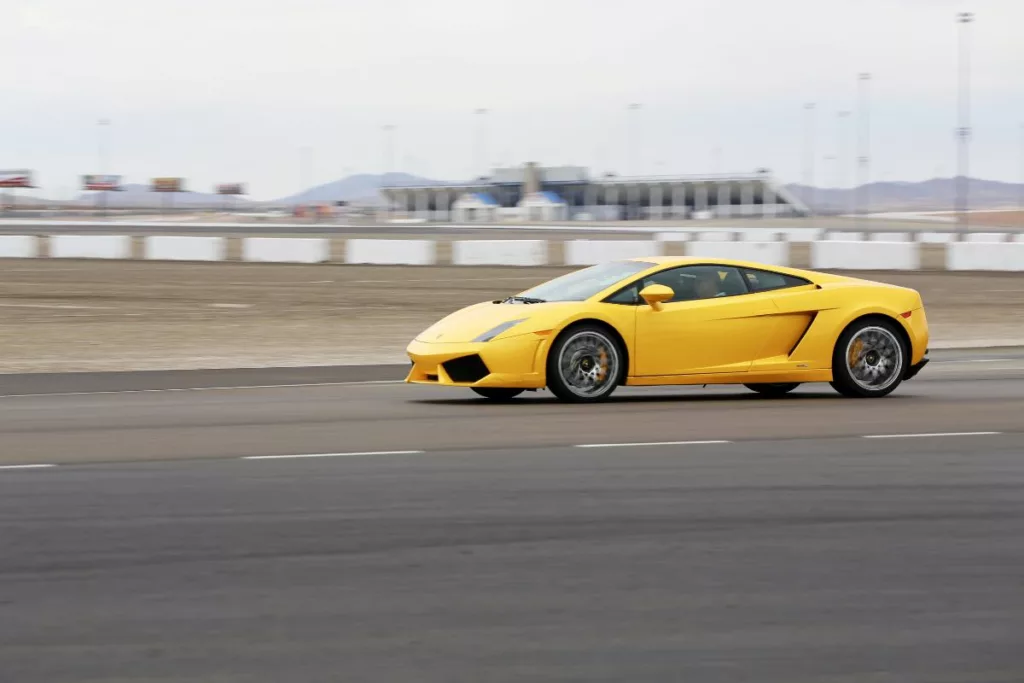 Yellow Lamborghini moving on a racetrack.