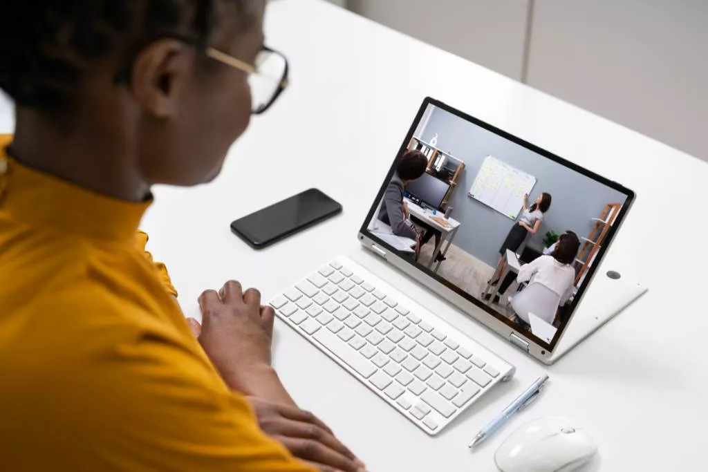 Woman watching a video presentation on her laptop.