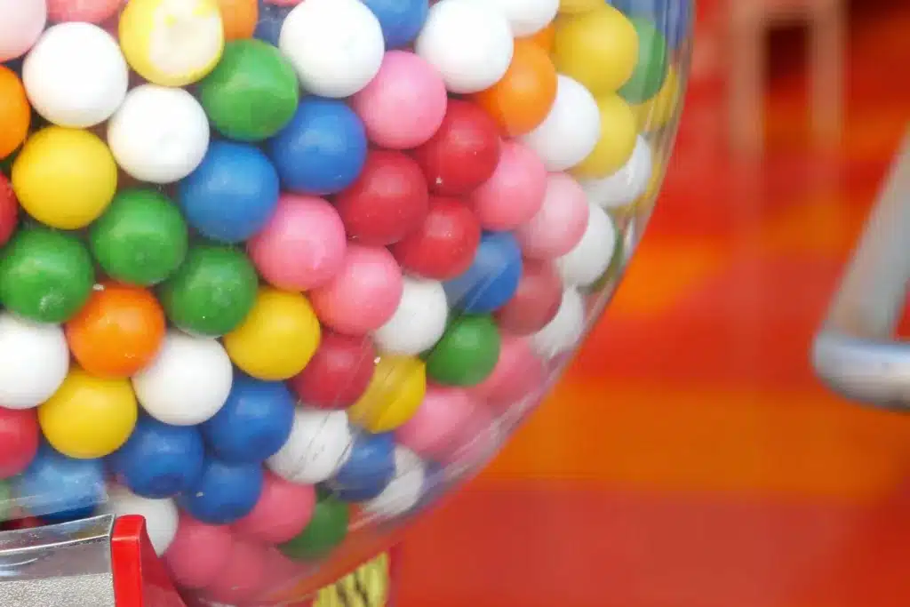 Jar filled with gumballs.