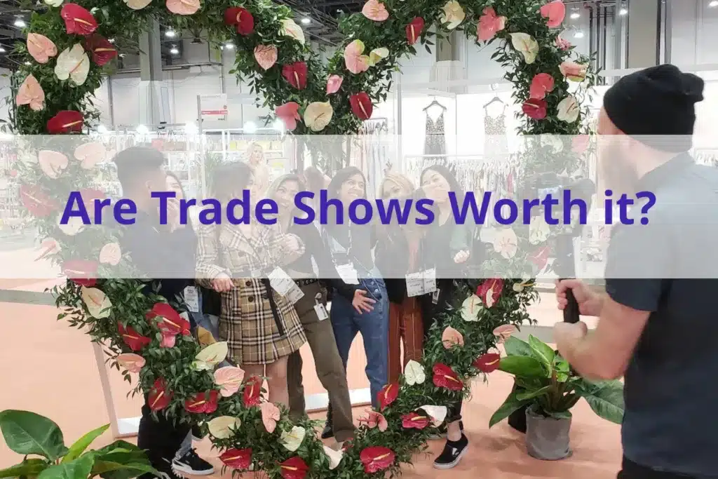 Text "are trade shows worth it" with a group of people posing in a heart made of flowers in the background.