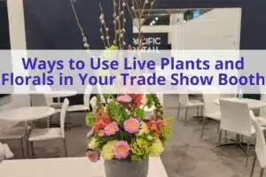 text "ways to use live plants and florals in your trade show booth' with image of a table with a floral centerpiece in the background