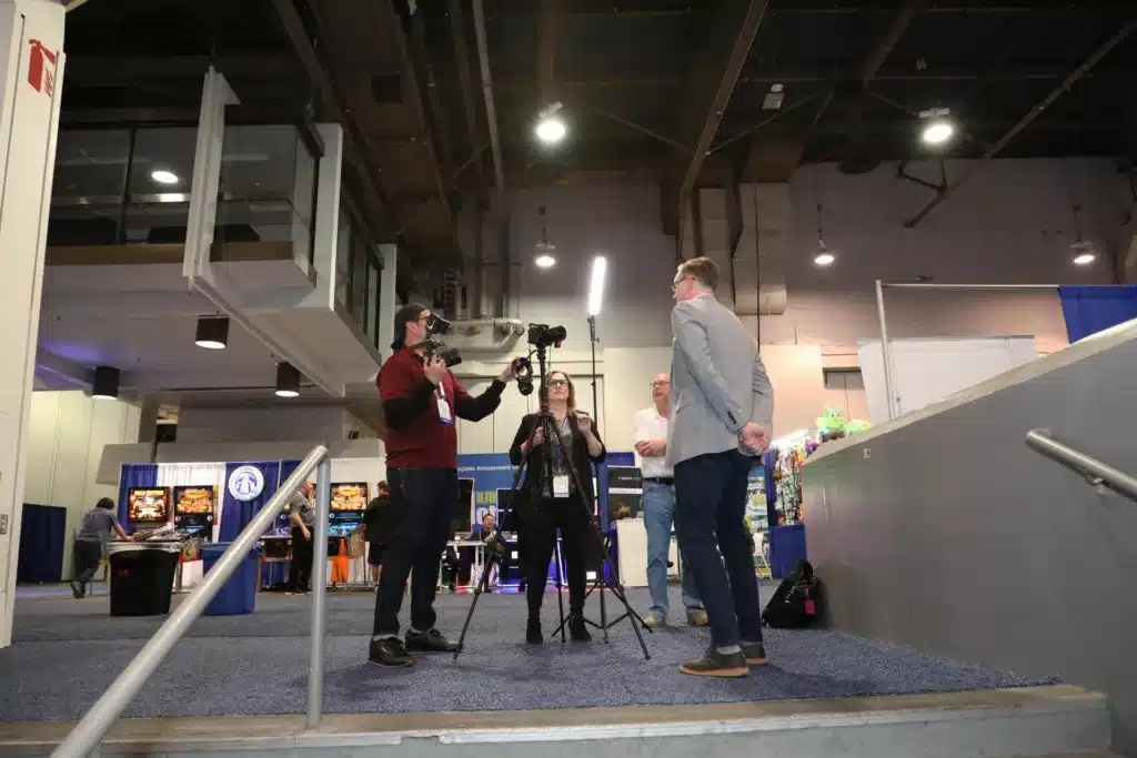 photographer taking video of a speaker at a trade show