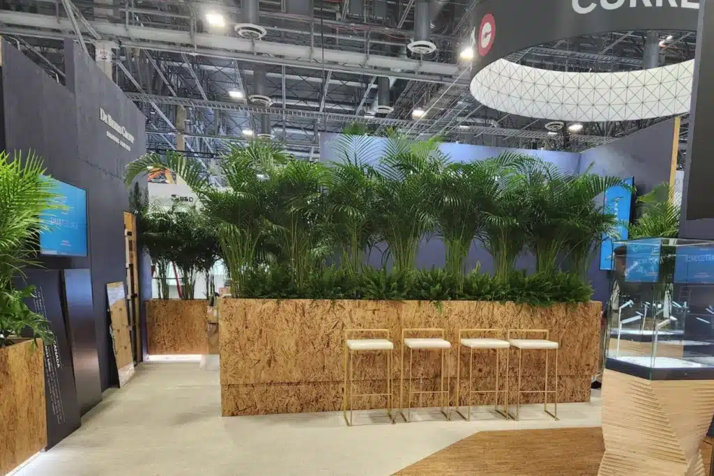 tall plants in a tall planter making a wall in a trade show booth