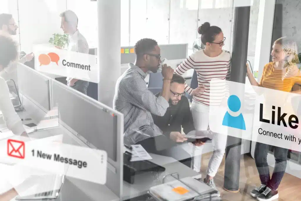 faded photo of people talking in an office with social media icons overlayed